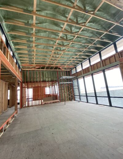 Spray Foam Insolation installed in a Large room with many windows. Well coted insolation for walls, ceilings and more.