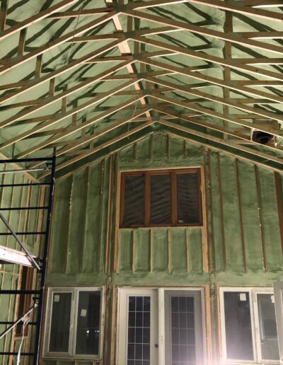 Spray Foam Insolation installed in a Large room with many windows. Well coted insolation for walls, ceilings and more.