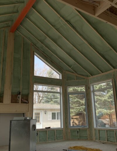 Spray Foam Insolation installed in a Large room with many windows. Well coted insolation for walls, ceilings and more.