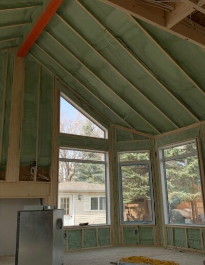 Spray Foam Insolation installed in a Large room with many windows. Well coted insolation for walls, ceilings and more.