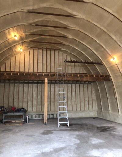 Spray Foam Insolation installed in a Large Industrial Space. Shop with well coted insolation.