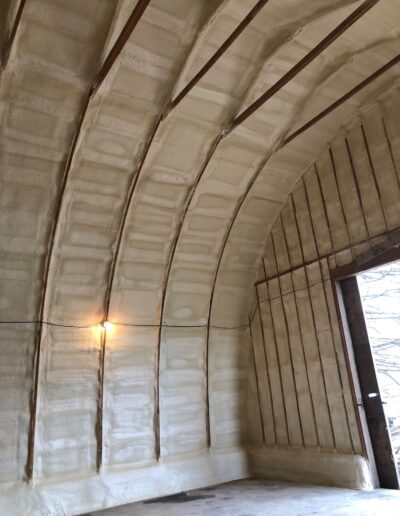 Spray Foam Insolation installed in a Large Industrial Space. Shop with well coted insolation.